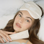 model wearing Sweet Dreams Eye Mask while holding Dream Crème