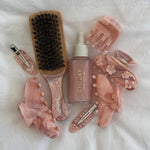 Mini Boar Bristle Brush in Pink Chantilly with assorted hair accessories and halo hair oil