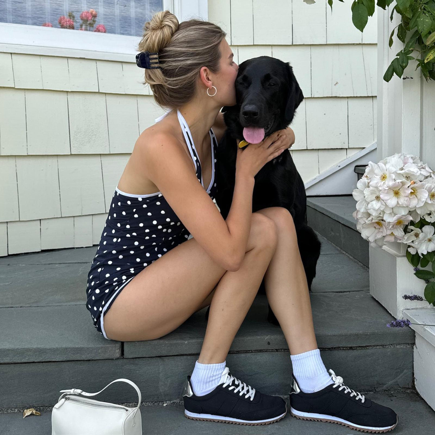 model wearing Petite Clip in Noir while sitting with a black dog